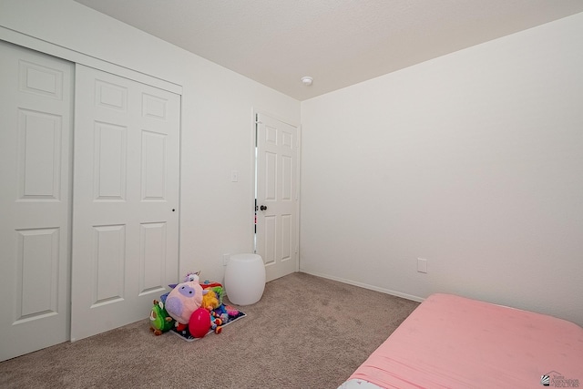 bedroom with light carpet and a closet