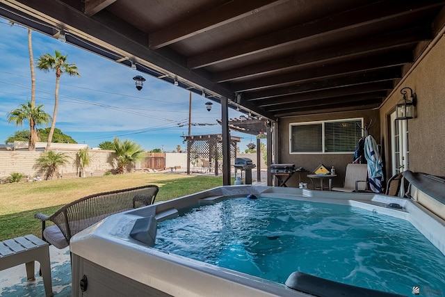 view of swimming pool featuring a lawn and a hot tub