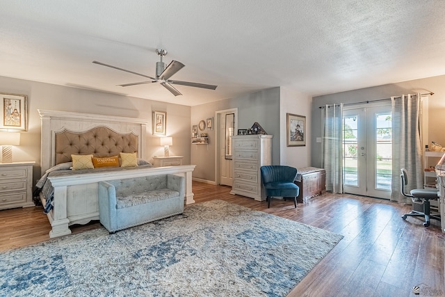 bedroom featuring a textured ceiling, wood-type flooring, french doors, access to outside, and ceiling fan