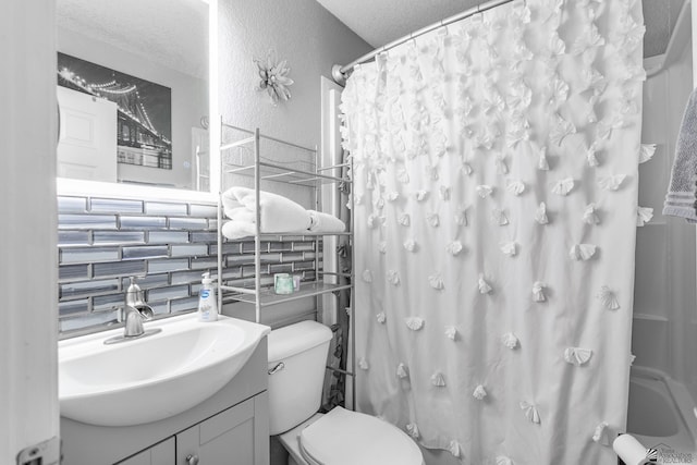 bathroom with a textured wall, toilet, shower / tub combo with curtain, a textured ceiling, and vanity