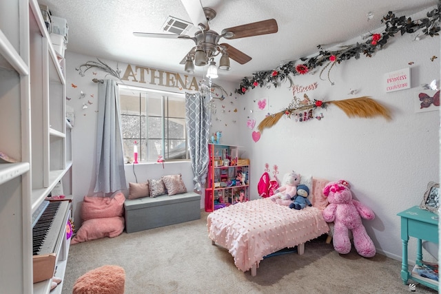 carpeted bedroom featuring a ceiling fan, visible vents, and a textured ceiling