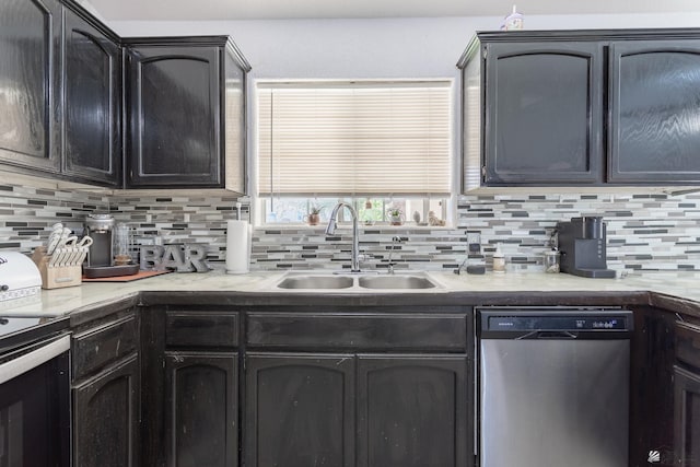 kitchen with stainless steel appliances, a sink, light countertops, and decorative backsplash