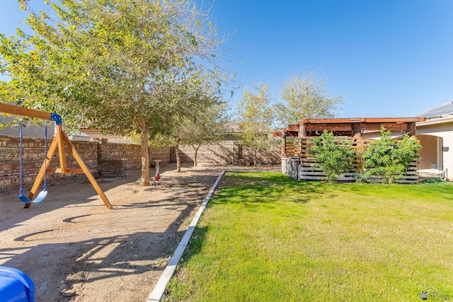 view of yard with a fenced backyard and a playground