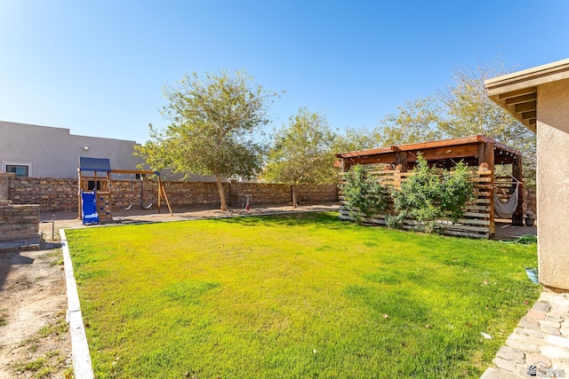 view of yard featuring a playground and a fenced backyard