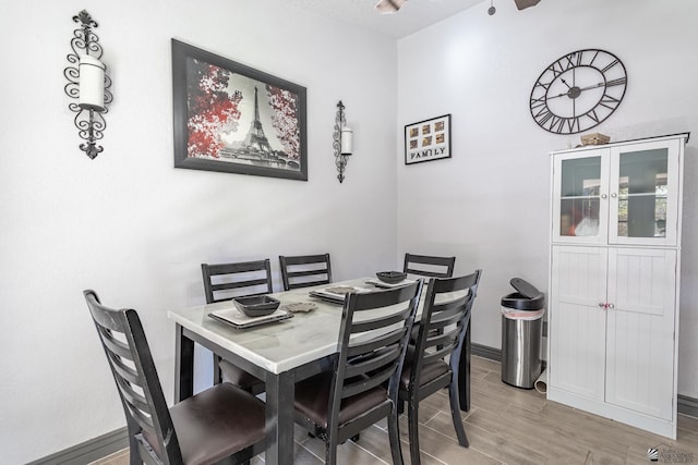 dining room featuring wood tiled floor and baseboards