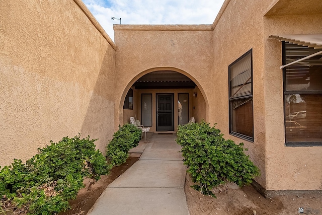 doorway to property with stucco siding