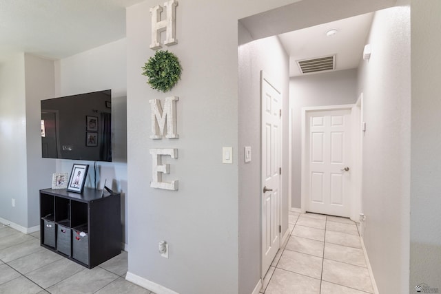 hall featuring light tile patterned floors