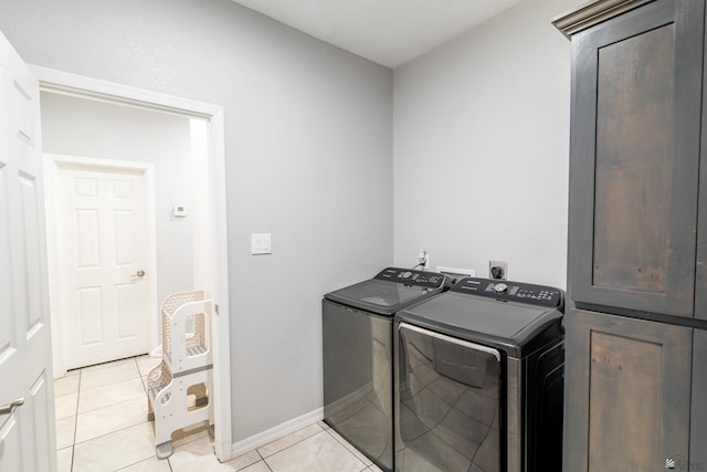 washroom with washer and clothes dryer and light tile patterned flooring