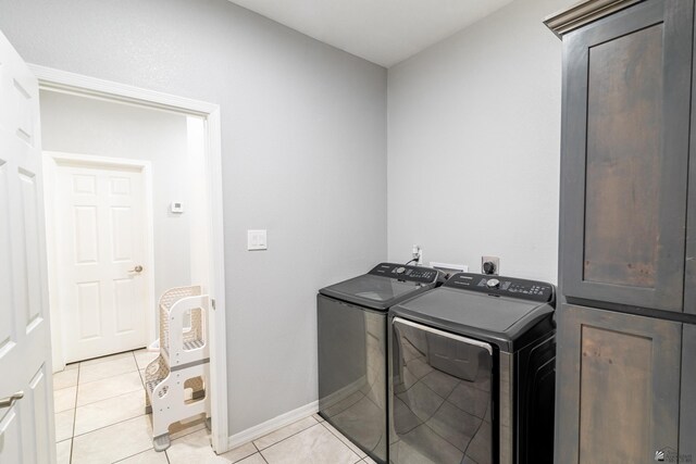 laundry room with light tile patterned flooring and independent washer and dryer