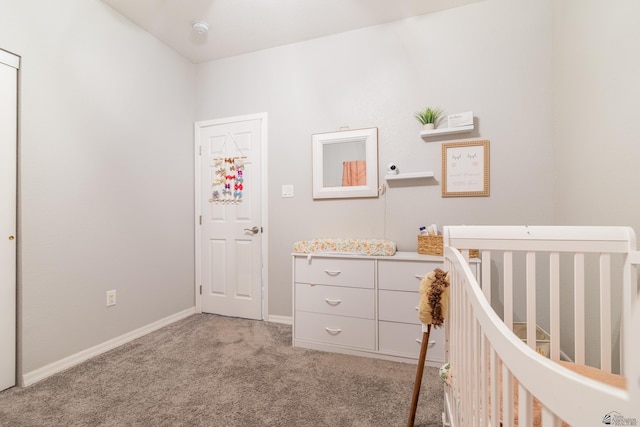 unfurnished bedroom featuring light colored carpet and a nursery area