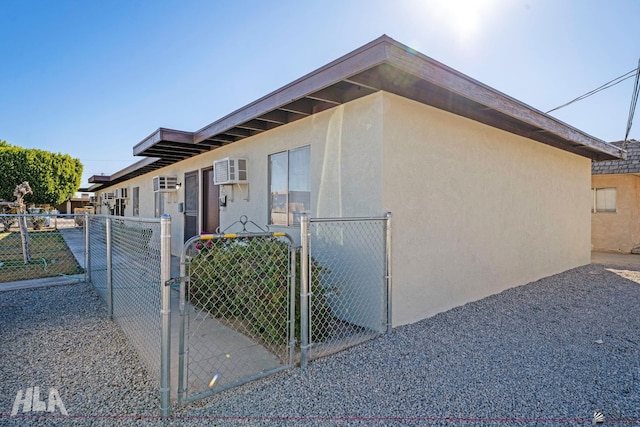 view of side of property with an AC wall unit