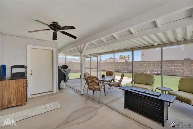 sunroom / solarium featuring ceiling fan