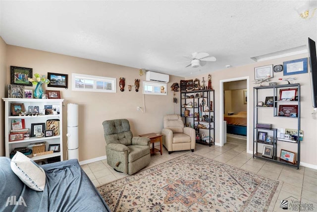 living room featuring an AC wall unit, ceiling fan, and light tile patterned flooring