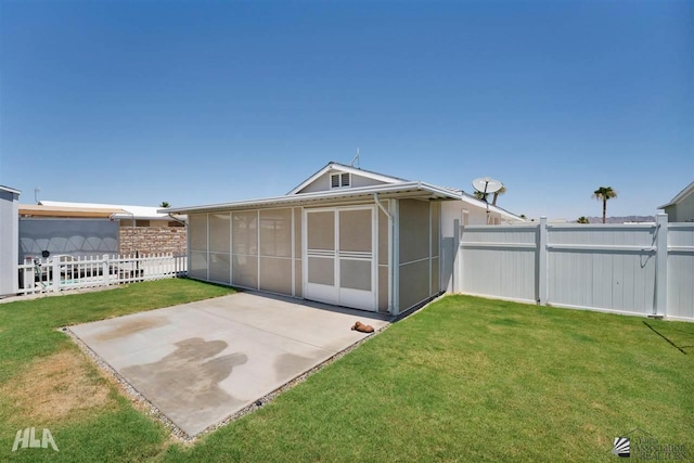 view of outdoor structure with a lawn and a sunroom