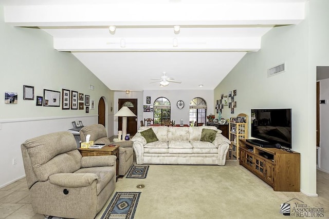 carpeted living room featuring vaulted ceiling with beams and ceiling fan