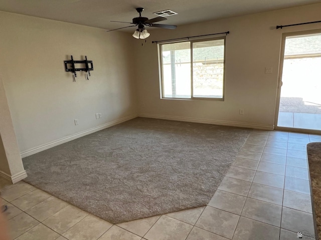 spare room featuring ceiling fan and light tile patterned flooring