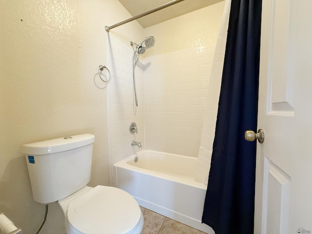 bathroom featuring shower / tub combo with curtain, tile patterned floors, and toilet