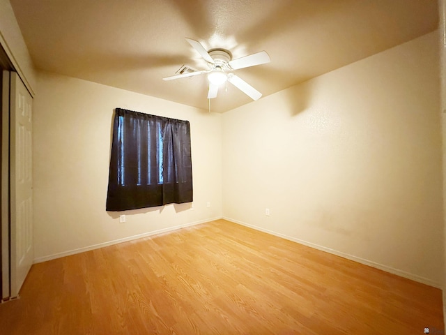 unfurnished room with ceiling fan and light wood-type flooring