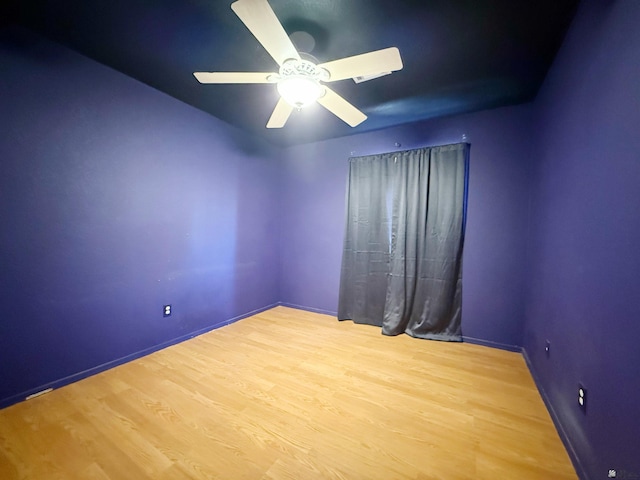 empty room featuring hardwood / wood-style flooring and ceiling fan