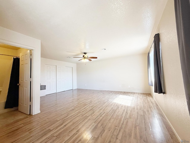 spare room featuring a textured ceiling, light hardwood / wood-style floors, and ceiling fan