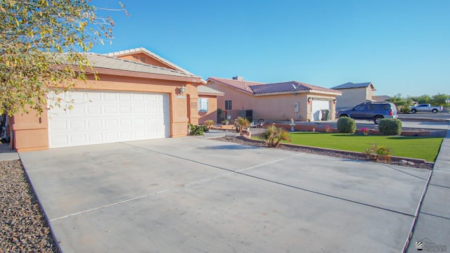 ranch-style house featuring a tiled roof, driveway, and stucco siding