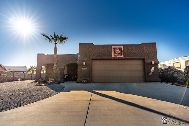 southwest-style home with a garage