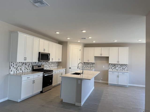 kitchen with white cabinetry, sink, and stainless steel appliances