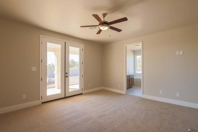 carpeted spare room with french doors and ceiling fan