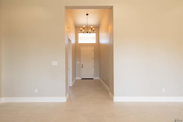 foyer with a towering ceiling and a notable chandelier