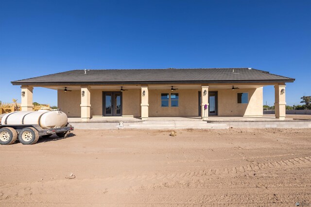 back of house with ceiling fan and french doors