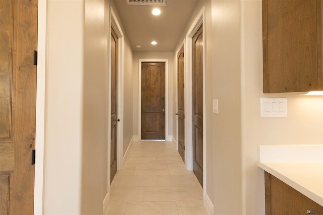 hallway featuring light tile patterned floors