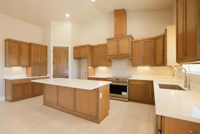 kitchen featuring high end range, sink, high vaulted ceiling, and a center island