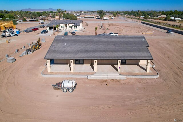 birds eye view of property with a mountain view