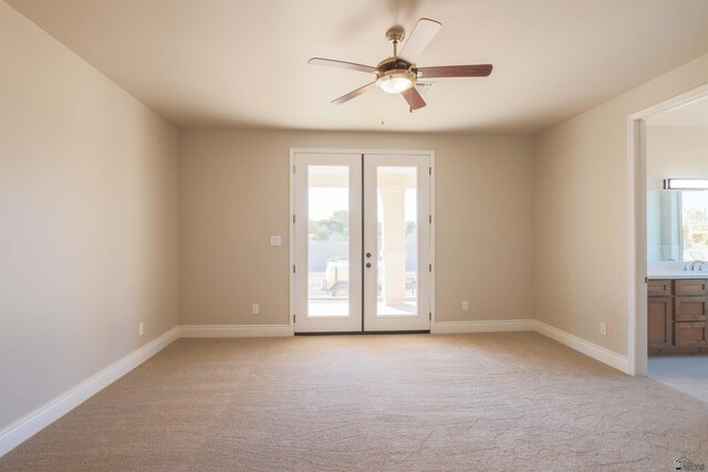 unfurnished room featuring light carpet, ceiling fan, and french doors