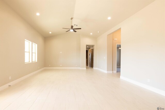 empty room featuring ceiling fan and lofted ceiling