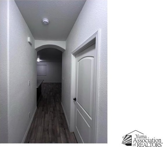 corridor with dark hardwood / wood-style floors