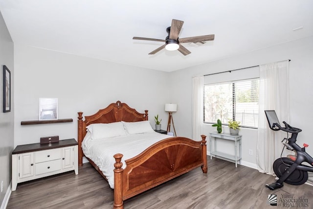 bedroom with wood finished floors, baseboards, and ceiling fan