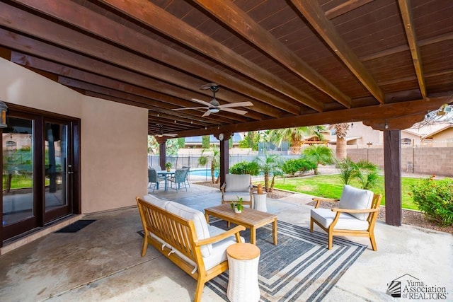 view of patio / terrace featuring an outdoor living space, fence, and ceiling fan