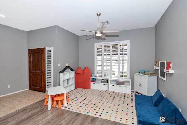 game room with visible vents, baseboards, a ceiling fan, and wood finished floors