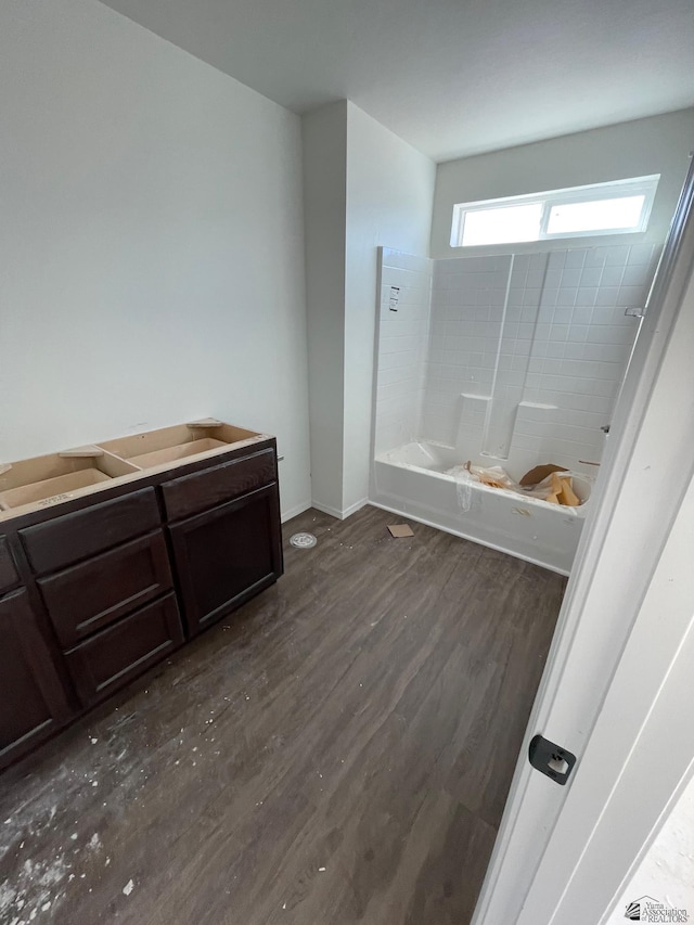 bathroom with tub / shower combination and wood-type flooring