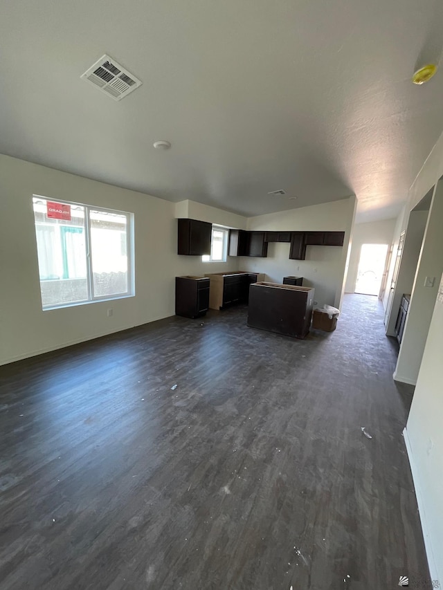 unfurnished living room with dark hardwood / wood-style floors