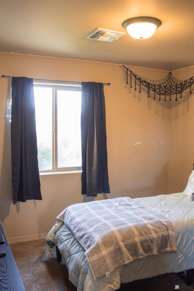 bedroom featuring carpet flooring, baseboards, and visible vents