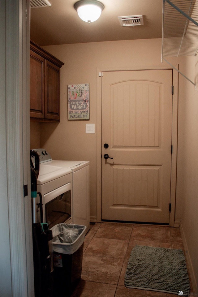 laundry room with baseboards, visible vents, washing machine and clothes dryer, cabinet space, and tile patterned floors