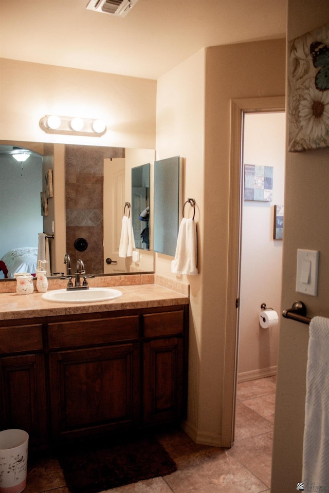 bathroom with visible vents, vanity, and ensuite bathroom