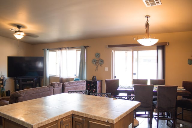 kitchen with a wealth of natural light, open floor plan, and tile counters