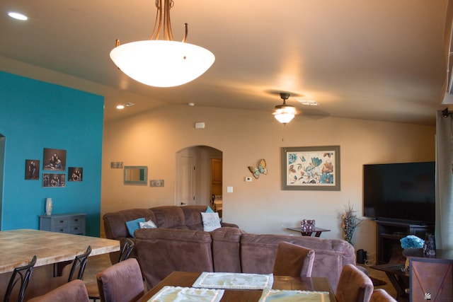 dining space with arched walkways, recessed lighting, ceiling fan, and lofted ceiling