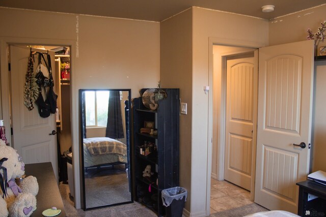 bedroom with a closet and light tile patterned flooring