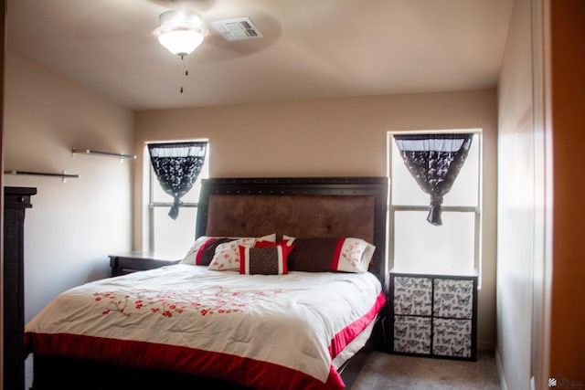 bedroom with visible vents, ceiling fan, and carpet flooring