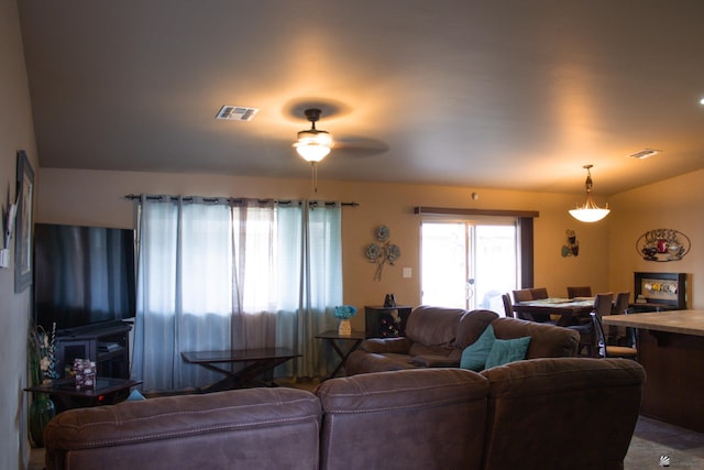 living area with visible vents and ceiling fan