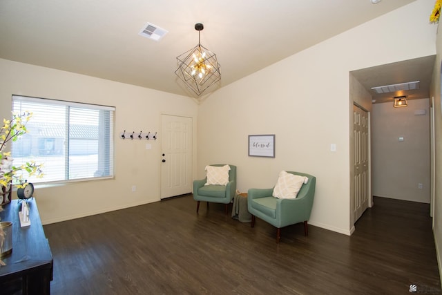 sitting room featuring dark wood-style floors, lofted ceiling, visible vents, and a notable chandelier